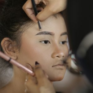 a woman getting her hair done by a professional hair stylist