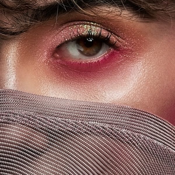 woman covering her face with gray textile